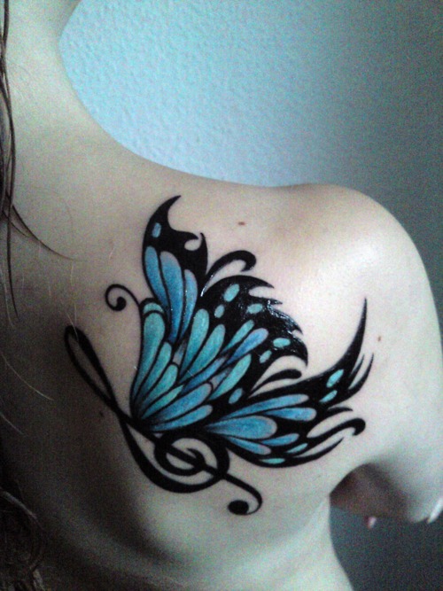 a big blue butterfly on a girl’s back / shoulder