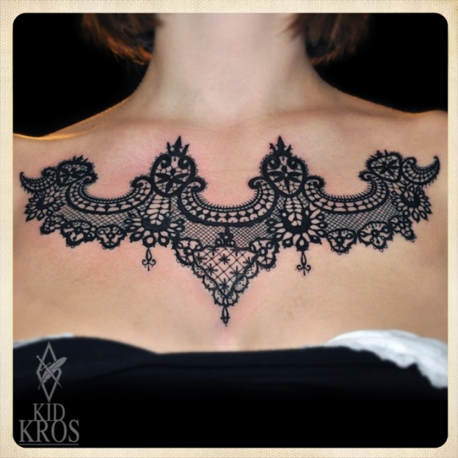Big black lace tattoo on girls chest