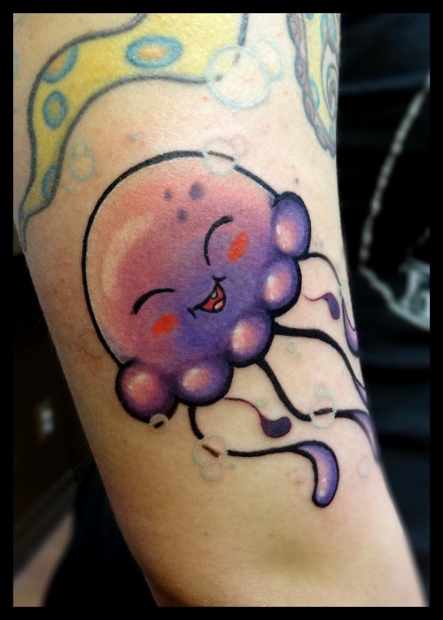 Cute happy purple jellyfish arm tattoo