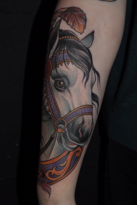 Beautiful white horse half-sleeve on girls arm