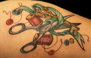 Colorful tattoo of scissors, ribbon, key, and tread