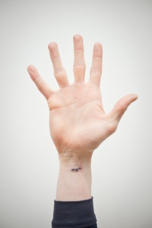 funny “me” trademark tattoo on girls wrist