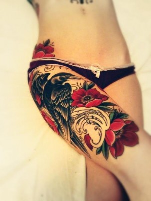 girls bird perched on roses tattoo on her leg
