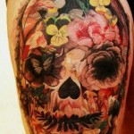 Mexican sugar skull from flowers leg tattoo