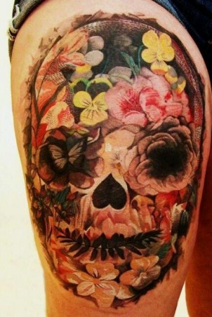 Super nice skull made of flowers tattoo on girls leg