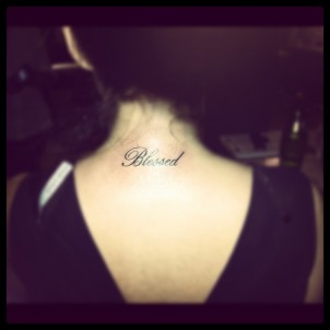 Blessed quote tattoo on back of girls neck