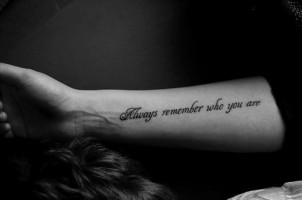 “Always remember who you are” quote tattoo on girls arm