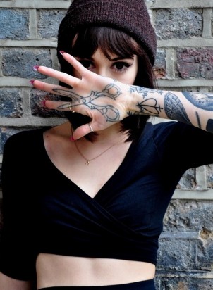 Girl’s scissors tattoo on her hand