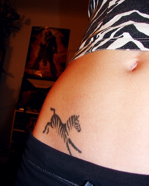 small and simple zebra tattoo on girl hip