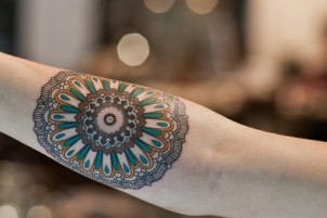 Girls round geometric patterns arm tattoo