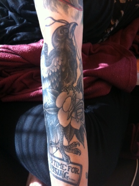 Black bird and rose tattoo part of girls sleeve