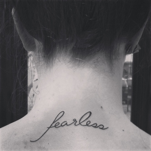 “Fearless” quote tattoo on back of girls neck