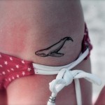 little whale tattoo on girls hip