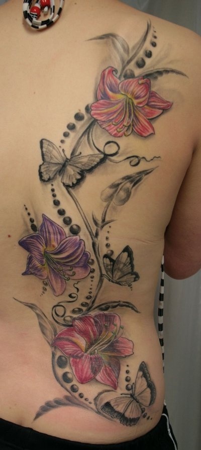 colorful lillies and black butterflies on right side of girls back
