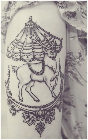 really cool reindeer on a carousel arm tattoo