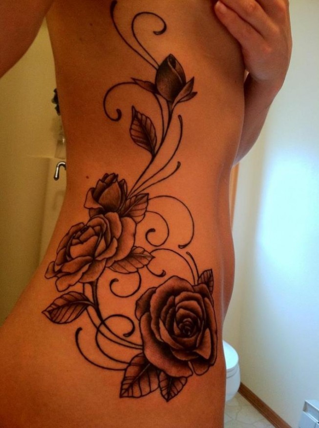 Black and white roses tattoo with vines on girls side