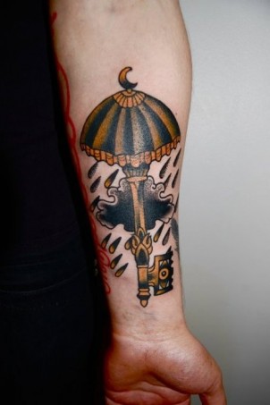 large key tattoo with umbrella on gorls arm