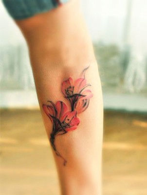 two elegant pink and red alstroemeria flowers on girls leg