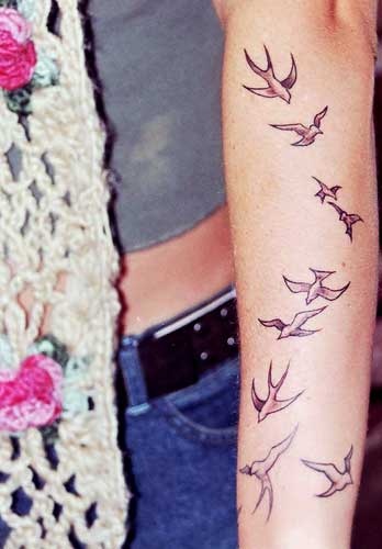 Nice and simple birds tattoo on girls arm