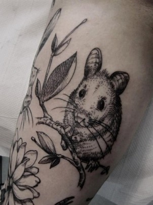 Lithograph-style field mouse tattoo on girls arm